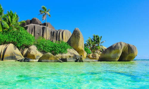 Image brown rock formation beside body of water during daytime