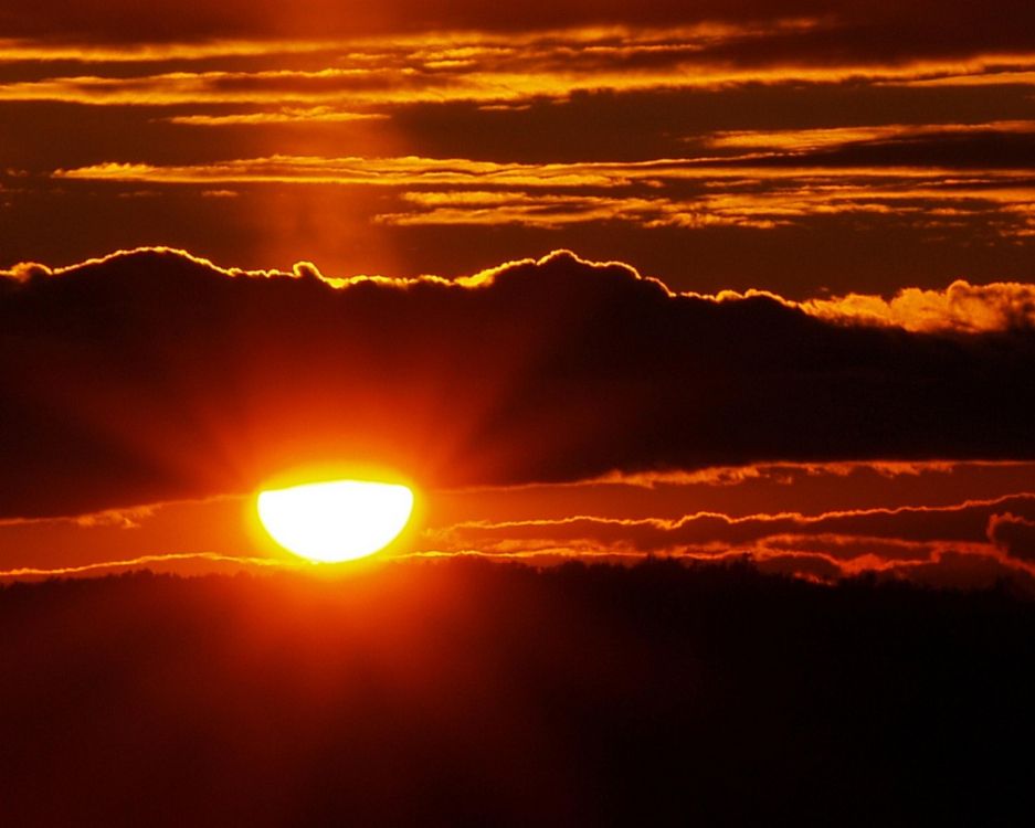 sun setting over the clouds