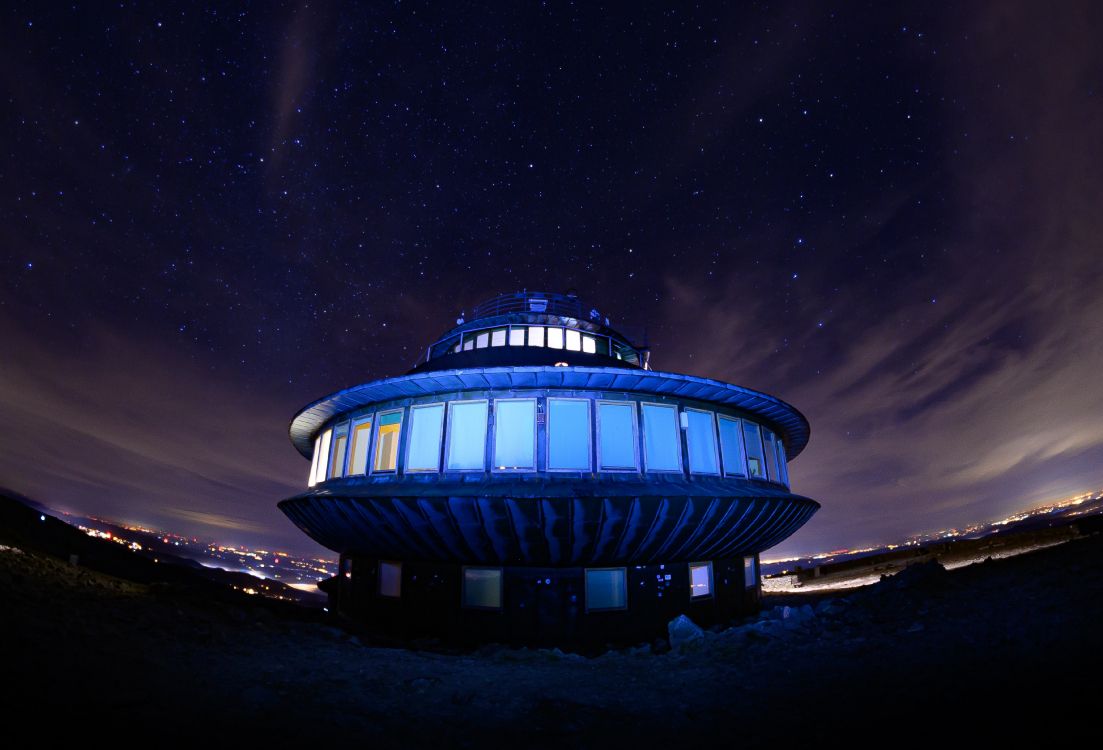 blue and white building under starry night