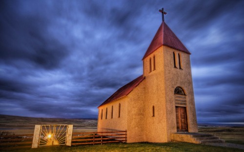 Image brown concrete church under cloudy sky