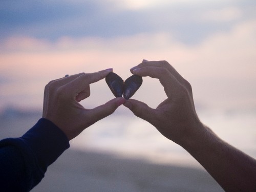 Image person holding black stone during daytime