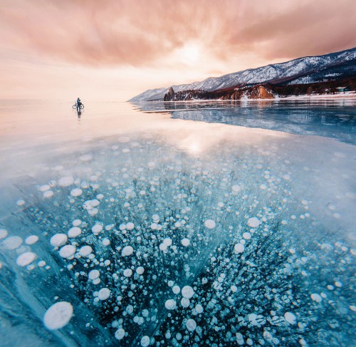 Image person standing on snow covered ground near mountain during daytime