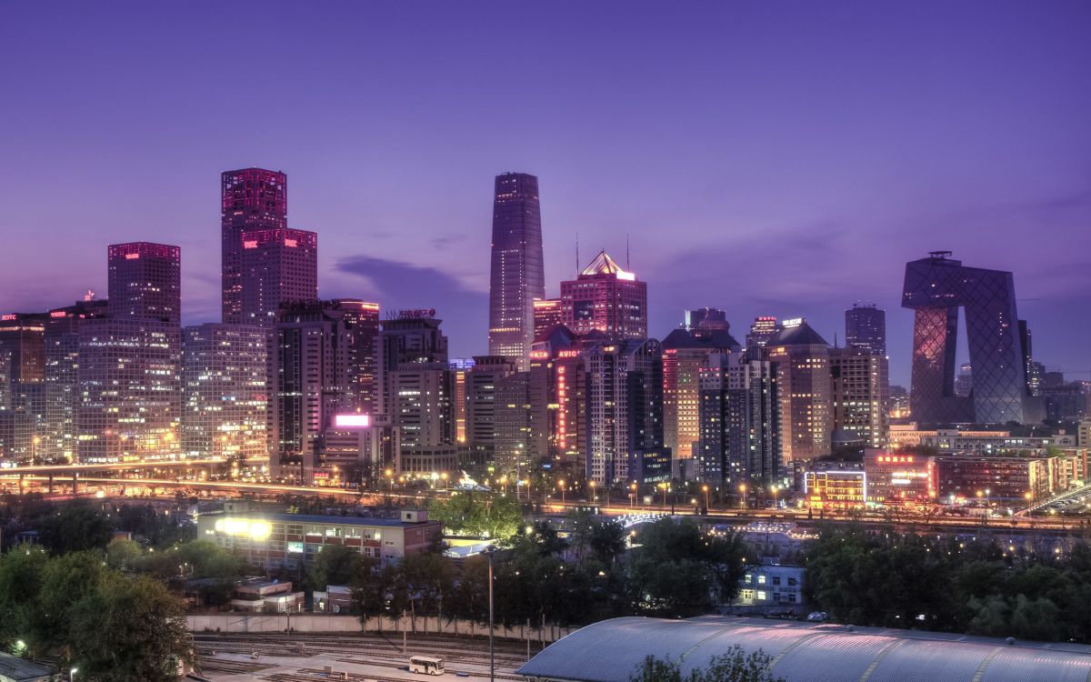 city buildings with lights turned on during night time