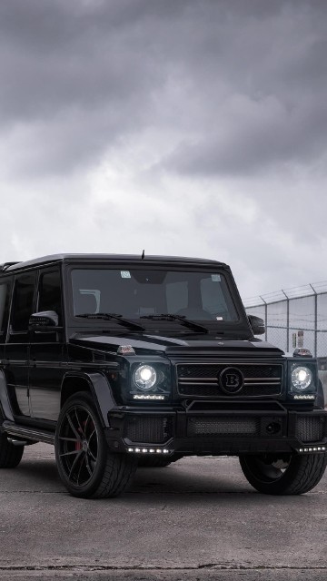 Image black jeep wrangler parked beside blue and white house under white clouds and blue sky during