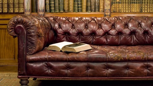 Image white book on brown leather couch