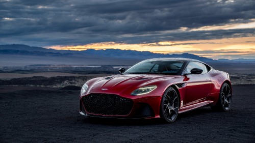 Image red porsche 911 on black asphalt road during sunset