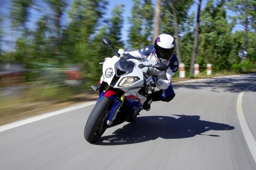 Image man in black helmet riding motorcycle on road during daytime