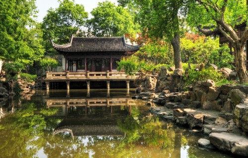 Image brown wooden house on river during daytime