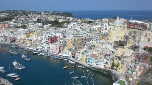 Image white and brown concrete buildings near body of water during daytime