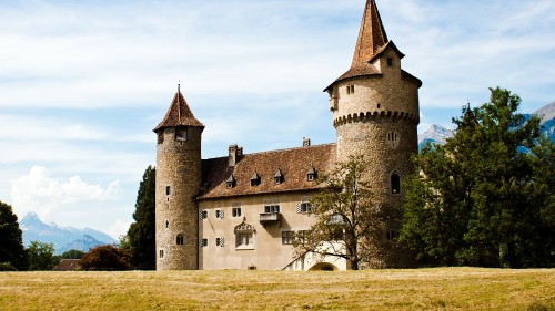 Image white and brown concrete castle under white clouds during daytime