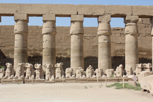 Image people standing near brown concrete building during daytime