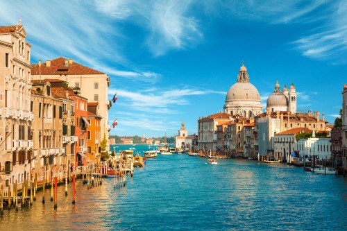 Image body of water between buildings under blue sky during daytime