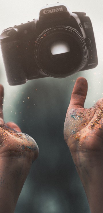 Image person holding black camera lens