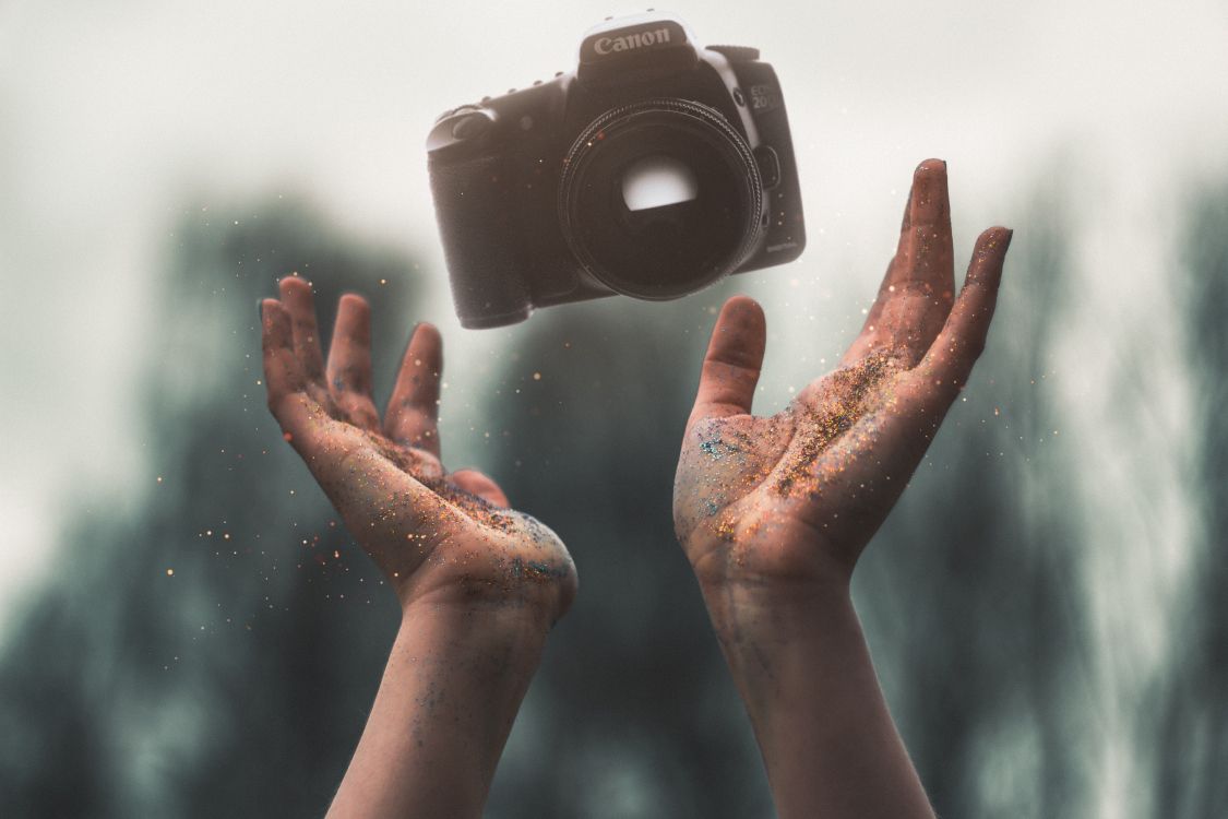 person holding black camera lens