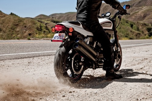 Image man in black jacket riding motorcycle on road during daytime