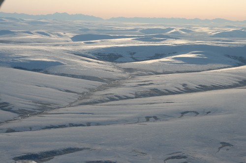 Image aerial view of snow covered mountains during daytime