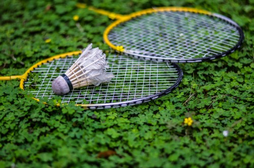 Image white and black tennis racket on green grass