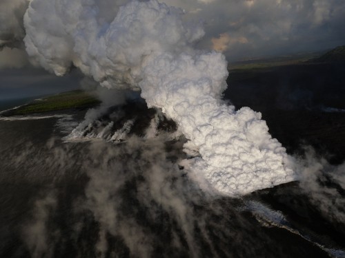 Image white smoke on green grass field during daytime