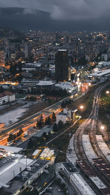 Image city with high rise buildings during night time