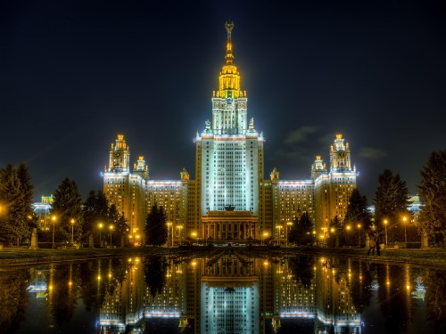 Image lighted building near body of water during night time