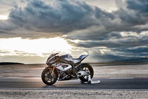 Image black and silver motorcycle on gray asphalt road under white clouds during daytime