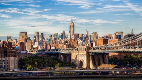 Image brown concrete bridge over city buildings during daytime