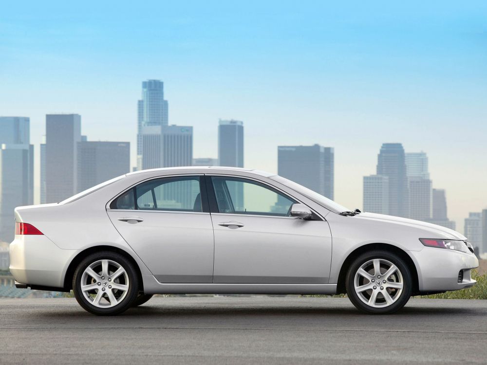 silver sedan on gray asphalt road during daytime