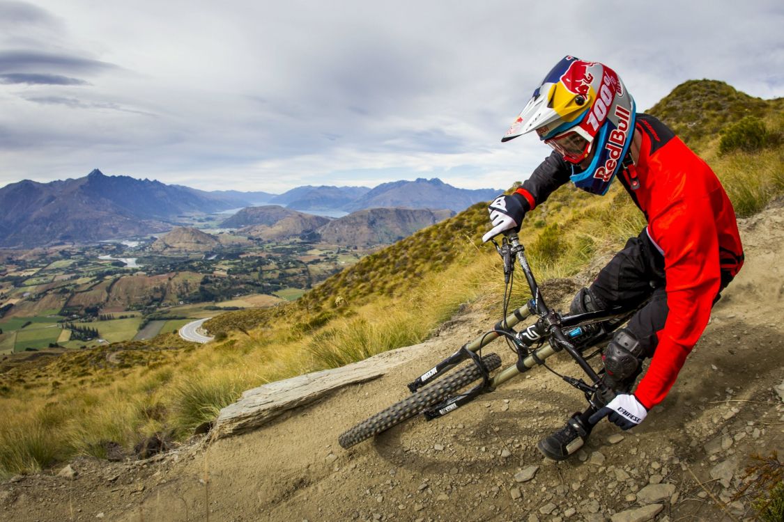 man in black jacket riding black mountain bike on road during daytime