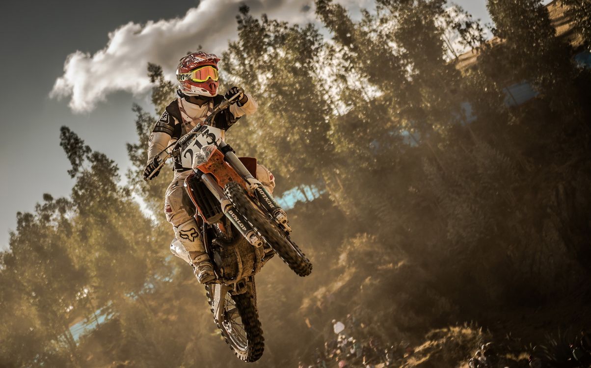 L'homme en Costume de Moto Orange et Noir Équitation Motocross Dirt Bike. Wallpaper in 2047x1275 Resolution