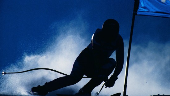 Image silhouette of man riding ski blades under blue sky