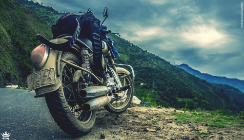 Image black motorcycle on green grass field during daytime