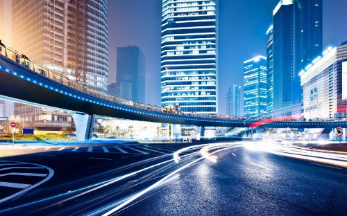 Image cars on road near high rise buildings during daytime