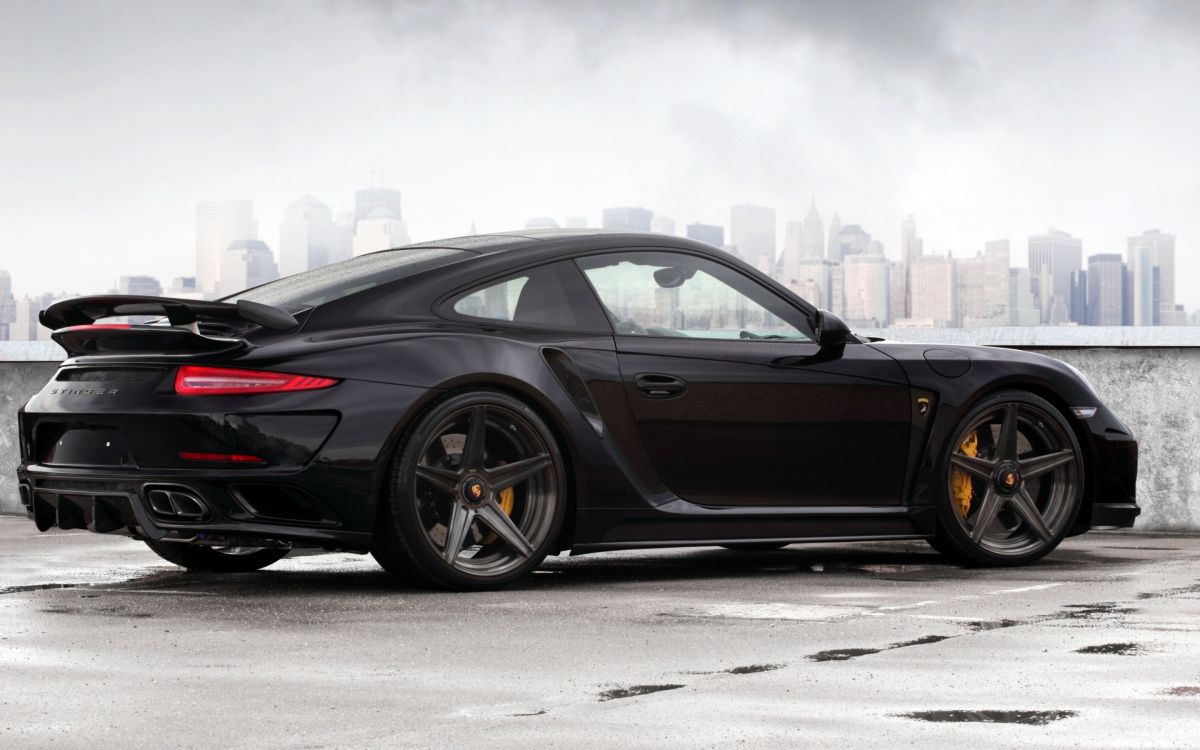 black coupe on gray asphalt road during daytime