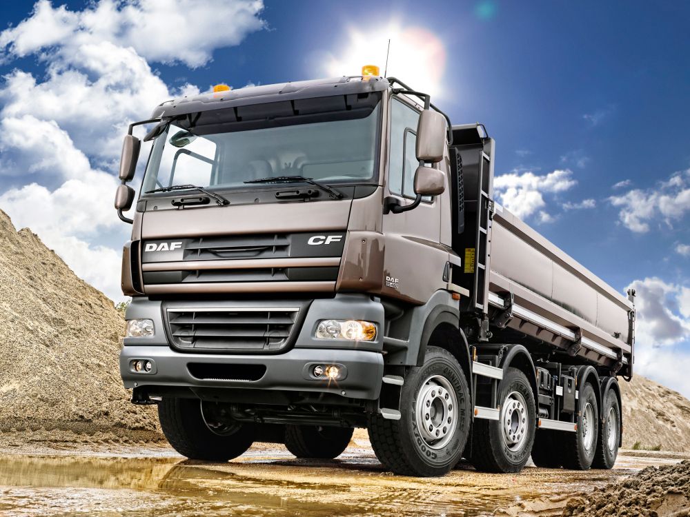 brown and gray truck on brown field under blue and white sunny cloudy sky during daytime