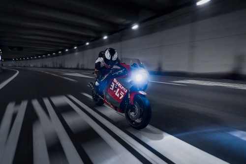 Image man in blue and black motorcycle helmet riding on red sports bike