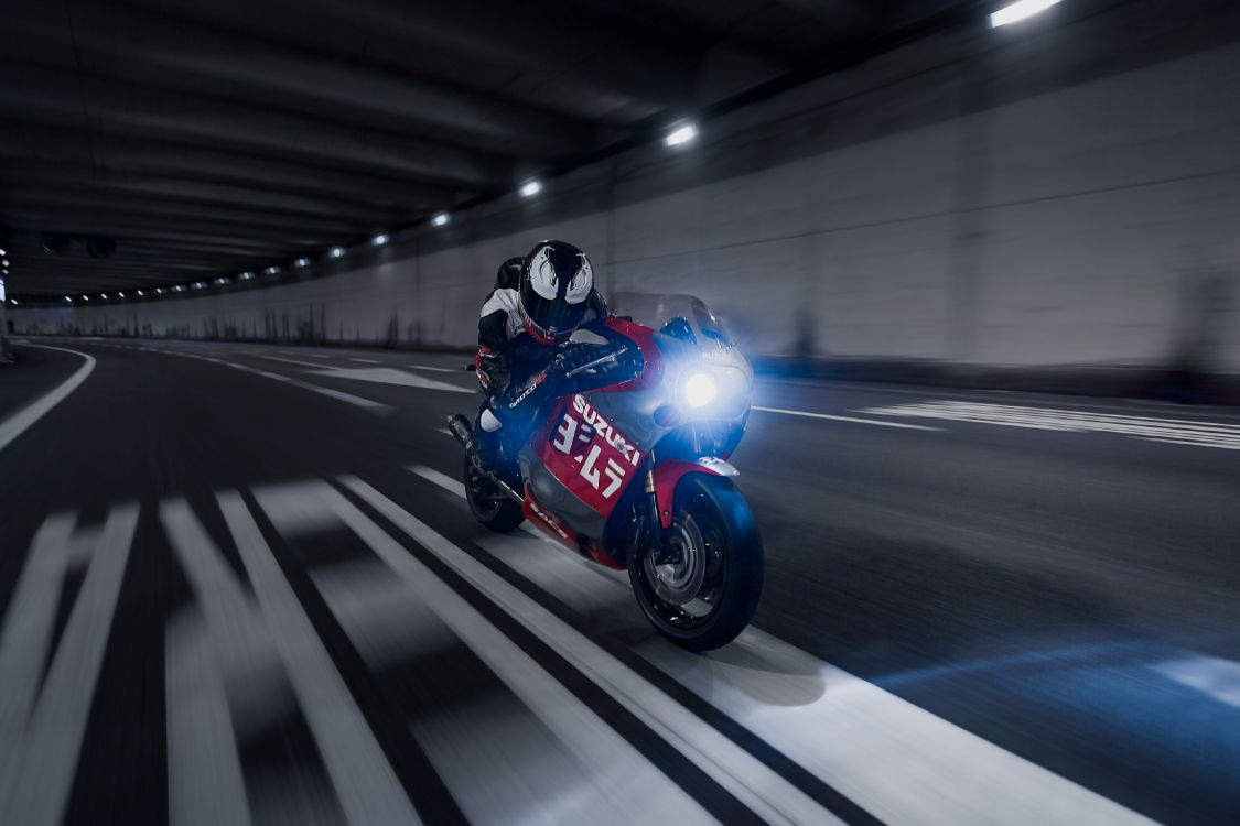 man in blue and black motorcycle helmet riding on red sports bike