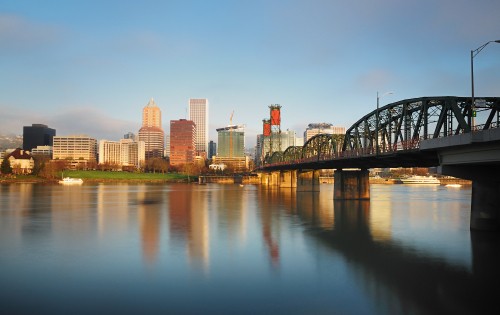 Image city skyline across body of water during daytime