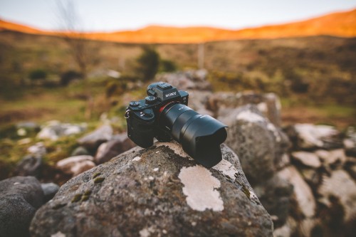 Image black dslr camera on rock