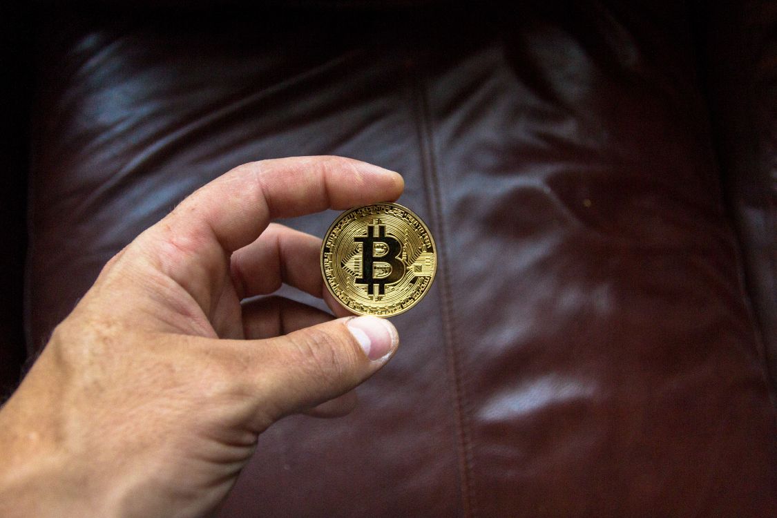 gold round coin on brown leather textile