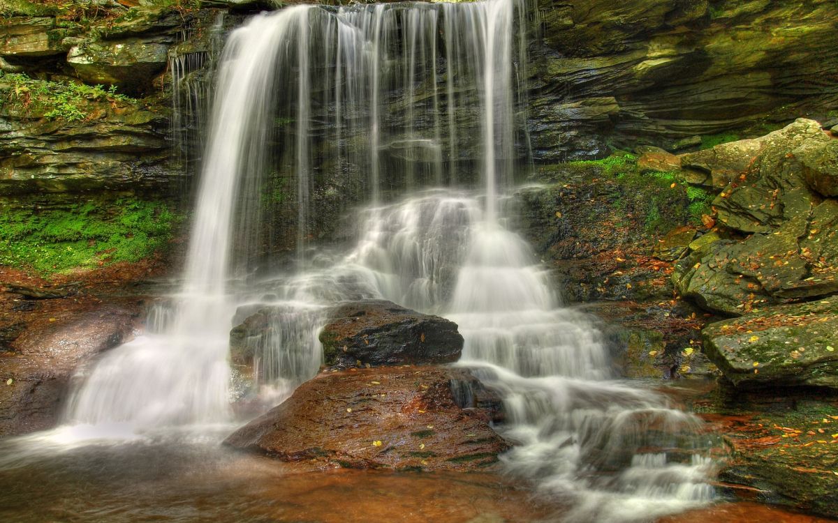 water falls on brown rock