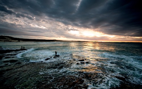 Image silhouette of 2 people on beach during sunset