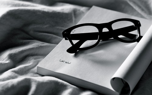 Image black framed eyeglasses on white paper