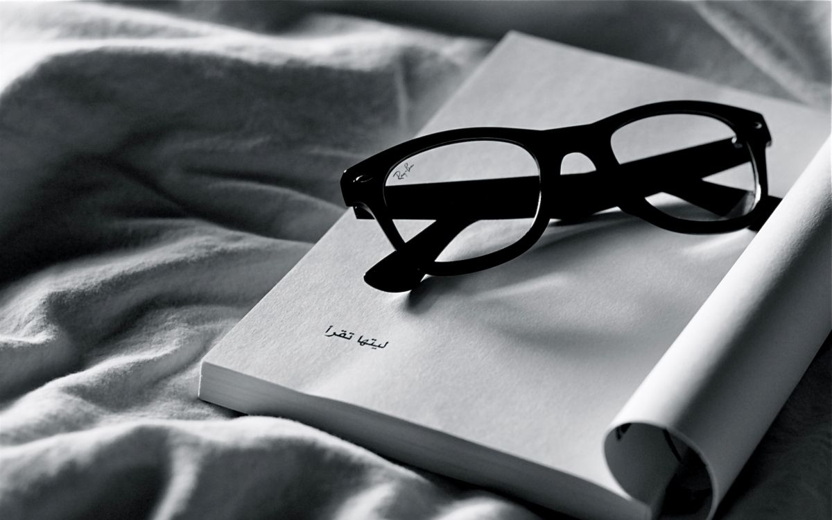 black framed eyeglasses on white paper