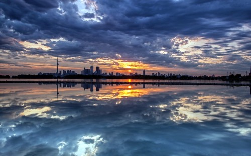 Image body of water under cloudy sky during sunset