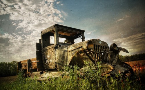 Image vintage car on green grass field under white clouds