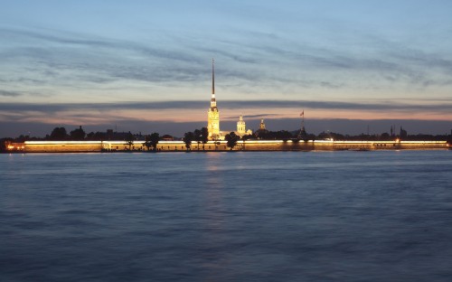 Image white and brown concrete building near body of water during daytime