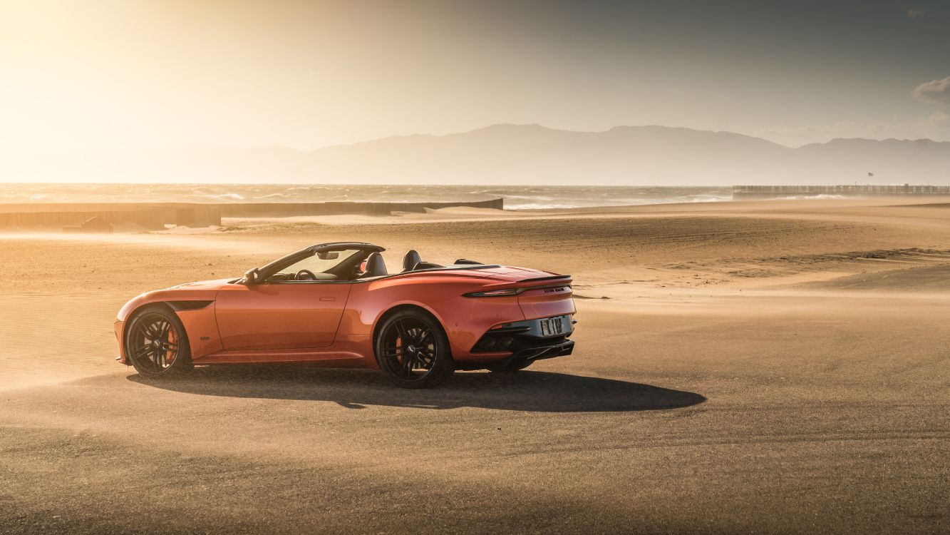 red chevrolet camaro on beach during daytime