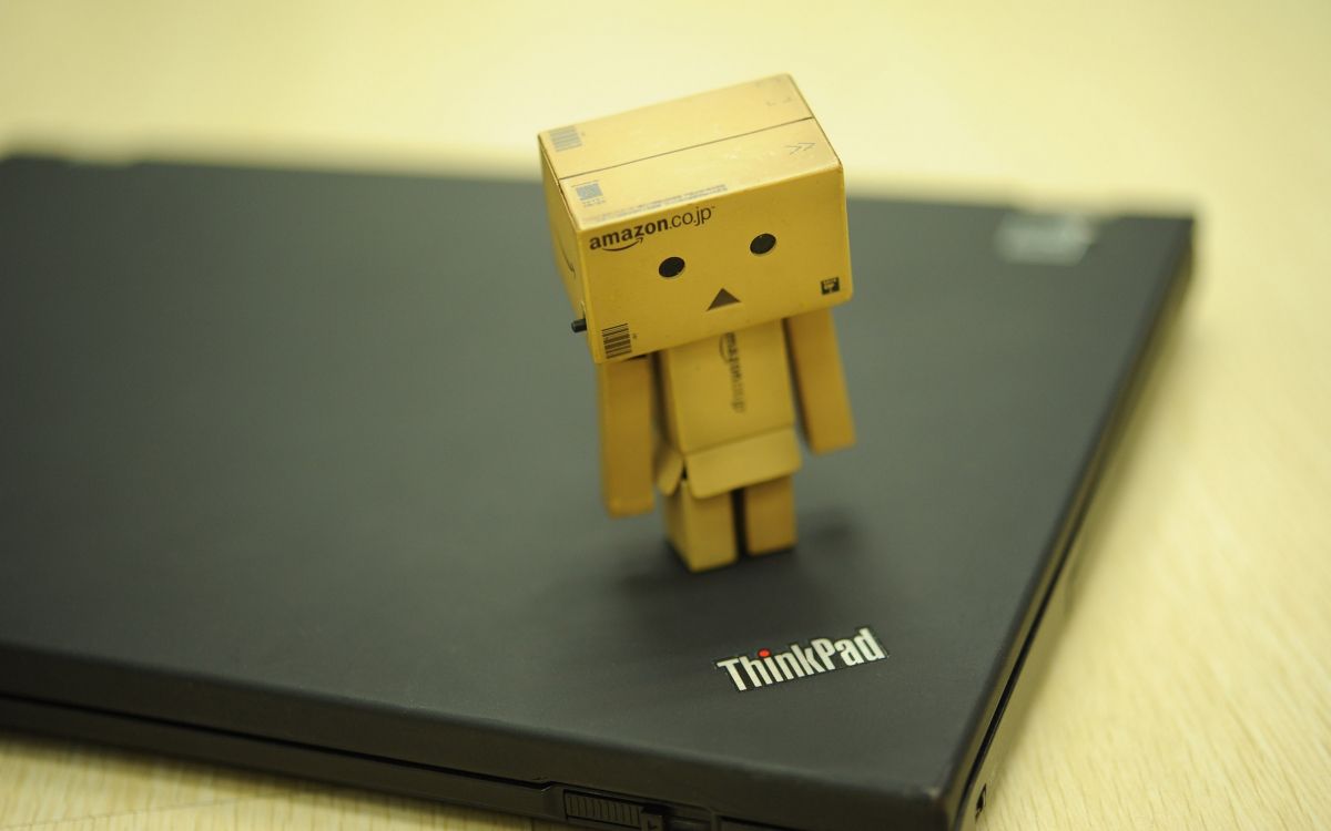 brown cardboard box on black lenovo thinkpad