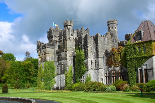 Image grey concrete castle under cloudy sky during daytime