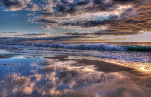 Image body of water under cloudy sky during daytime